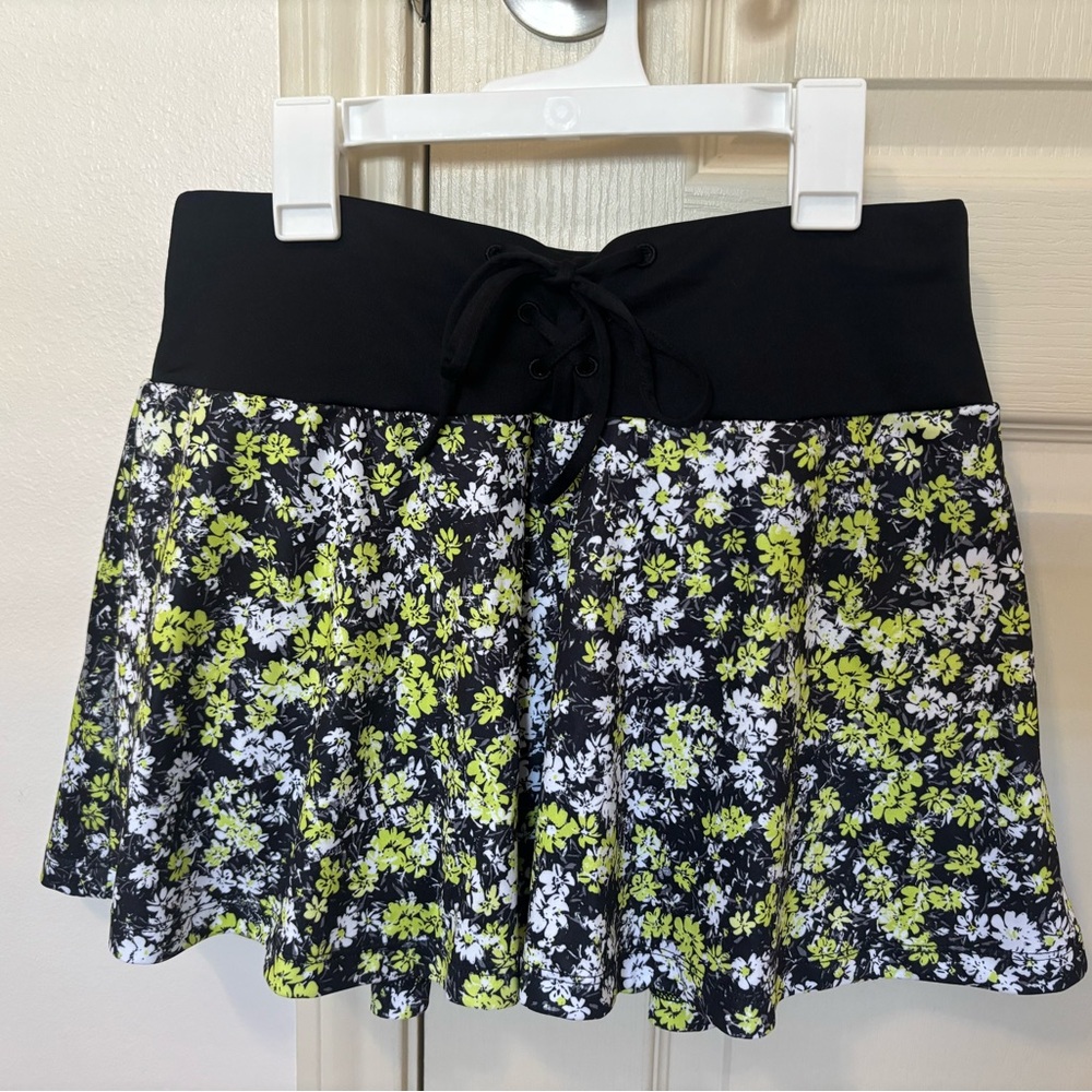 Grand Slam Black and Green Floral Skater Skirt shorts underneath.